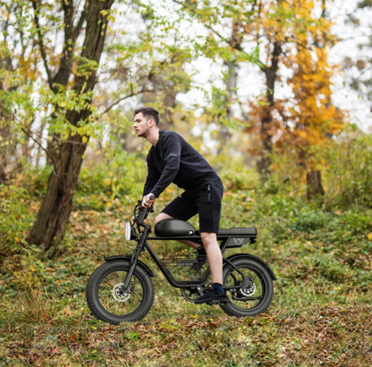 Young rider riding Windhorse D5 electric bike on a forest trail demonstrating comfortable off-road performance.