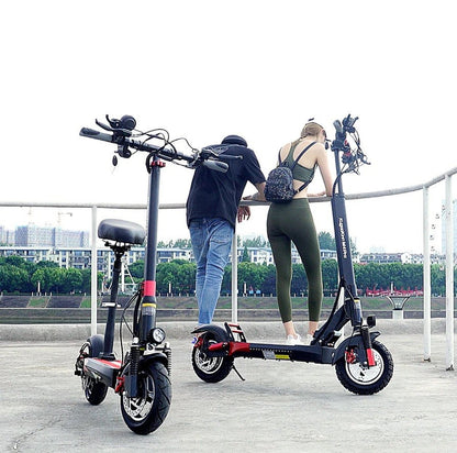 Kugoo M4 Pro electric scooters with removable seats parked beside riders outdoors.