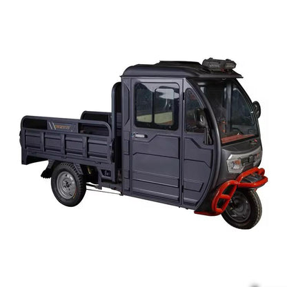 electric three-wheel cargo vehicle front side angle showing heavy-duty commercial design.